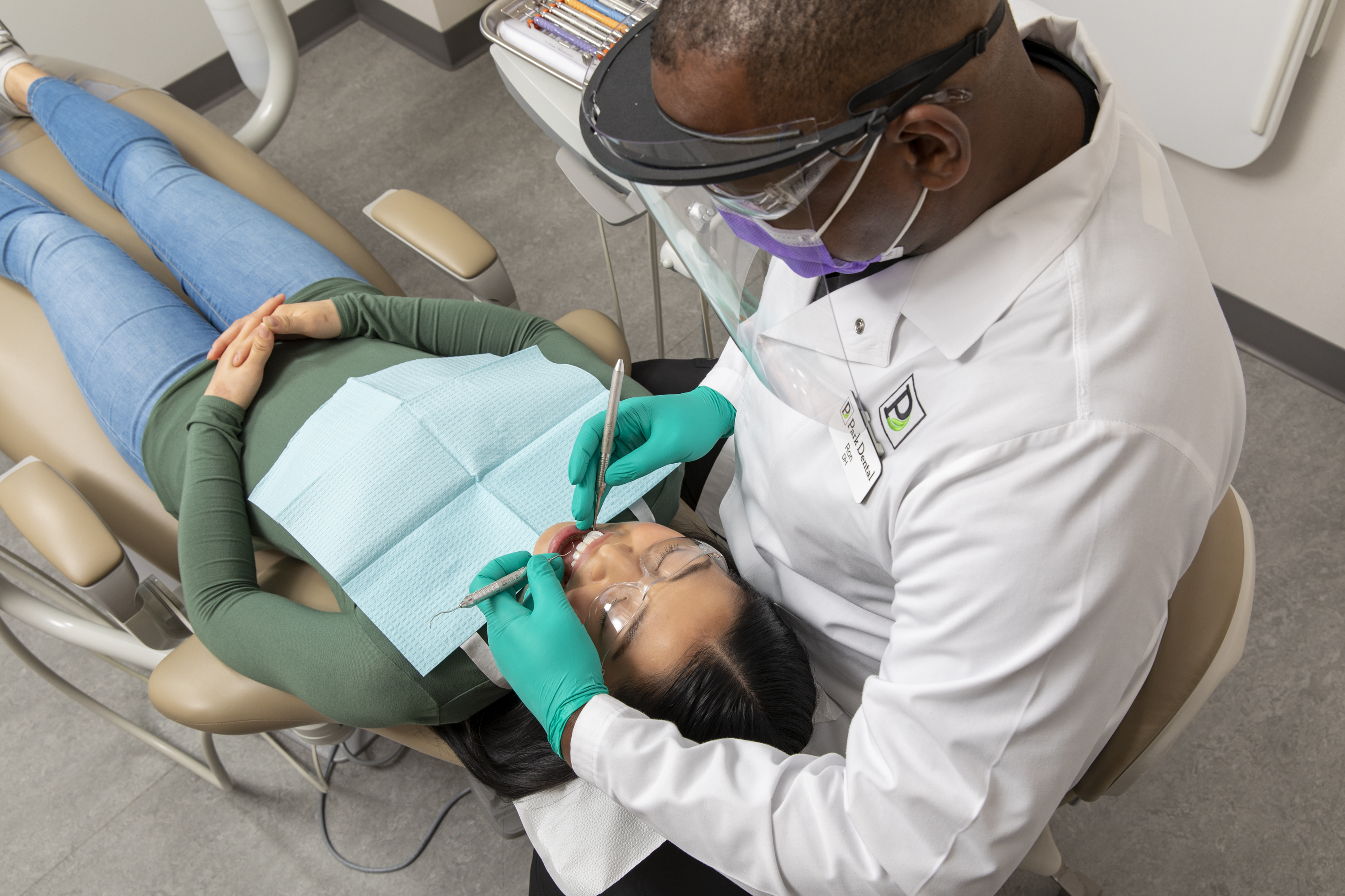 Woman in dentist chair for teeth cleaning